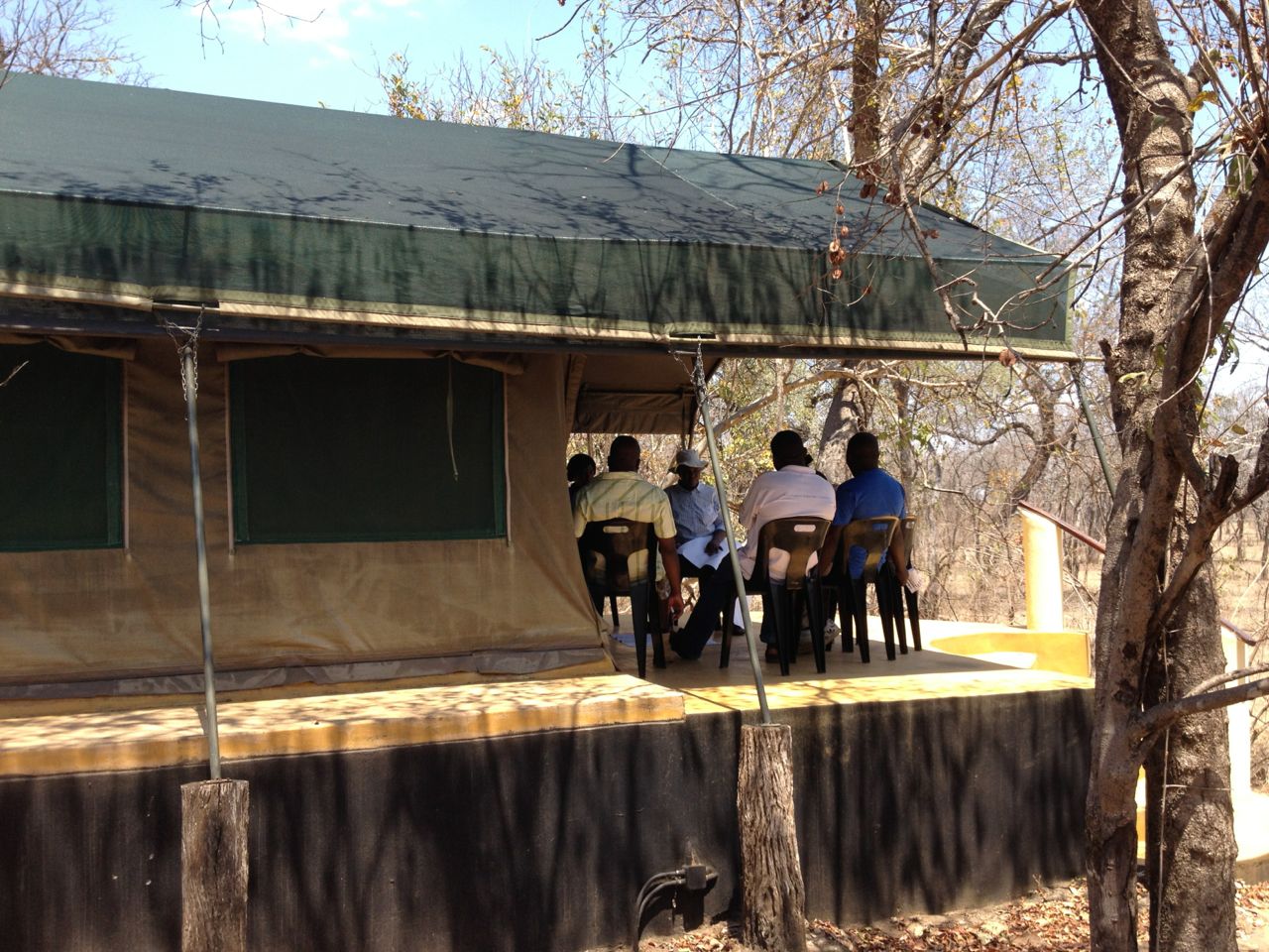 Small group discussion on the veranda of one of the accommodation tents.